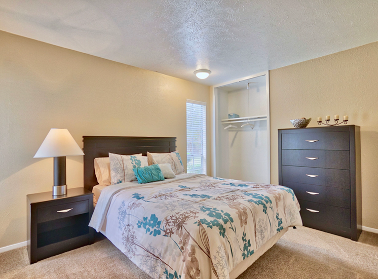 bedroom with window l Woodlands of Plano Apartments in Texas